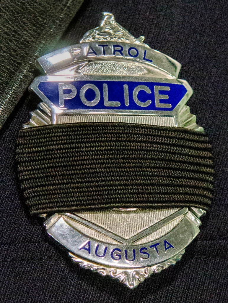 Augusta police Officer Carly Wiggin and other law enforcement officers wore black bands on badges during Donald Williams' funeral on Saturday at the Maine Criminal Justice Academy in Vassalboro.