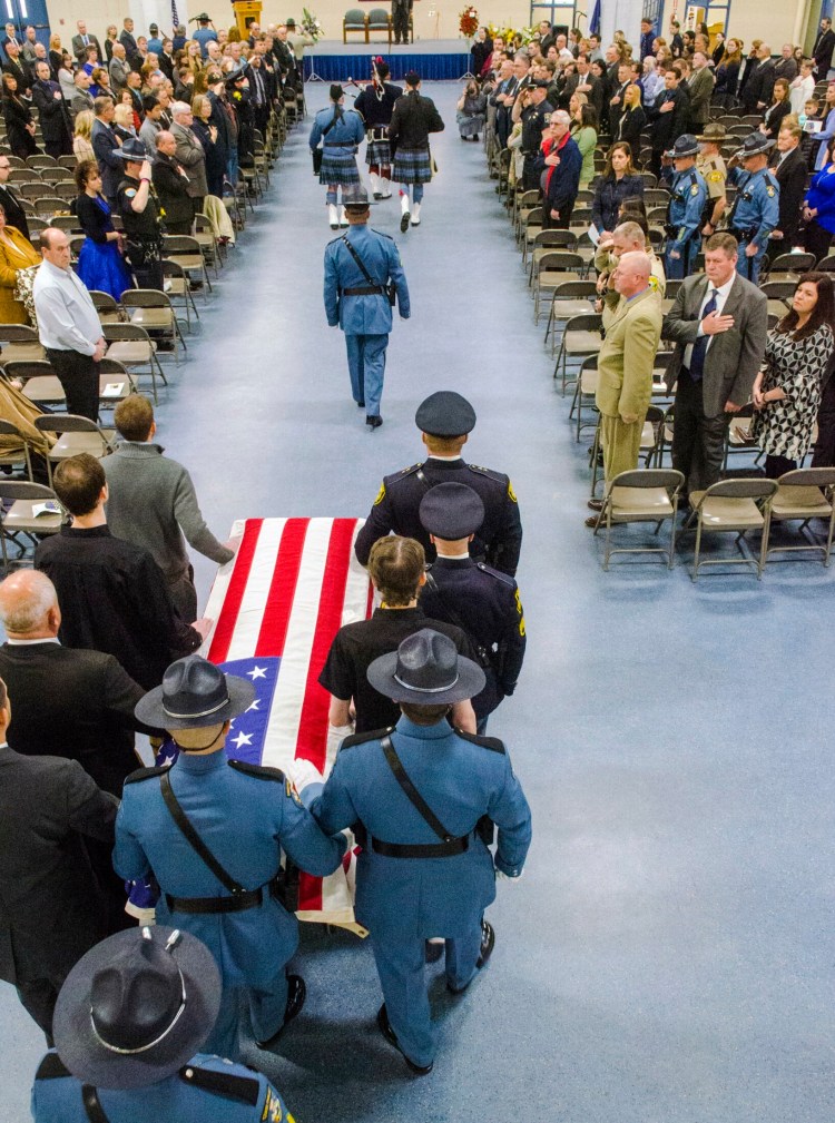 Pallbearers bring Donald Williams' casket in at the start of his funeral at the Maine Criminal Justice Academy in Vassalboro. 