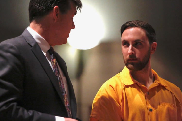 Mark Cardilli Jr., right, listens to his attorney, Jon Gale, during a court appearance Tuesday to face a murder charge in the shooting death of Isahak Muse in Portland last month.