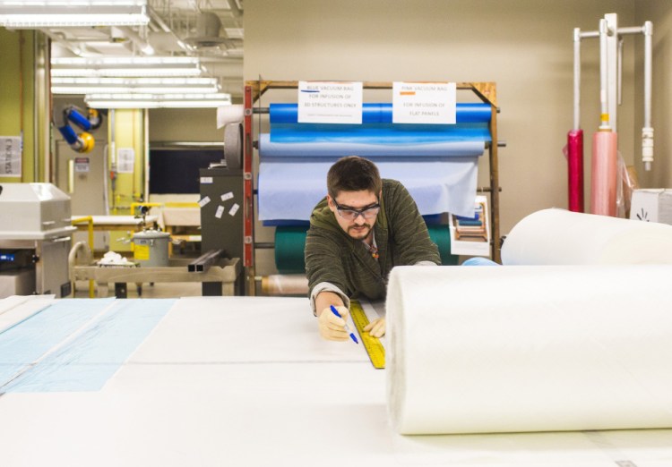 A technician cuts a piece of mesh polypropylene at Southern Maine Community College in Brunswick in 2015. The Composite Engineering Research Laboratory is moving to the University of Southern Maine.