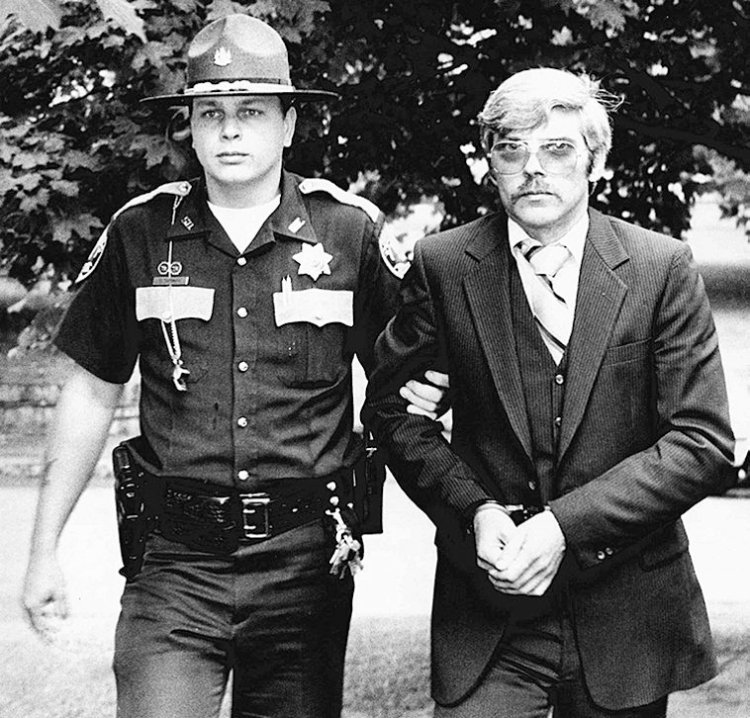 Michael Boucher, right, is escorted by Kennebec County Deputy Eric Testerman on July 9, 1991.