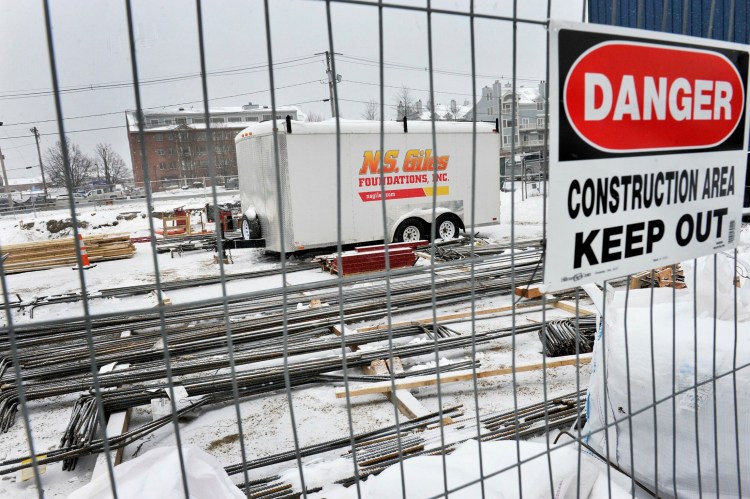 Materials are piled on a commercial construction site on Union Wharf on Portland's waterfront in late 2017. Real estate analysts say the recent dip in commercial real estate activity could be a signal that the economy is starting to cool. 