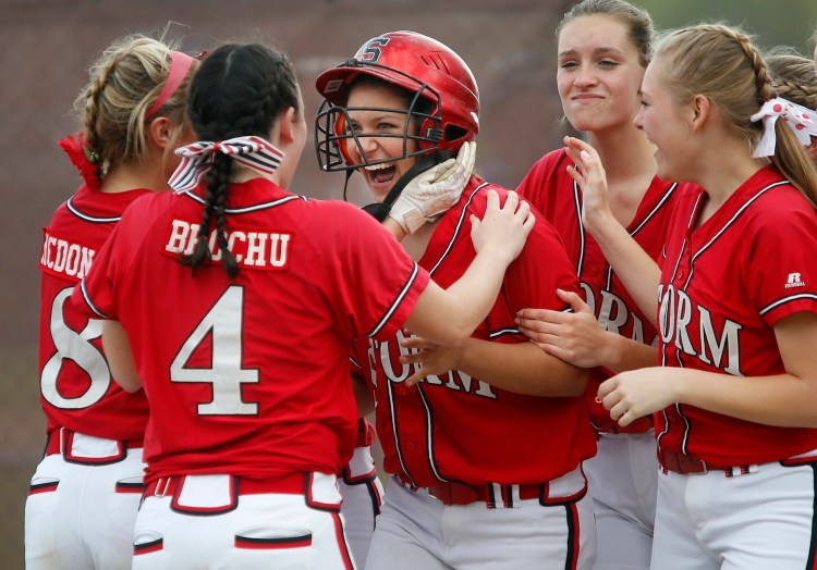 SACO, ME - MAY 18: Scarborough vs Thornton Academy softball. Katherine Roy of Scarborough is congratulated by teammates after hitting a home run in the second inning. (Staff photo by Derek Davis)