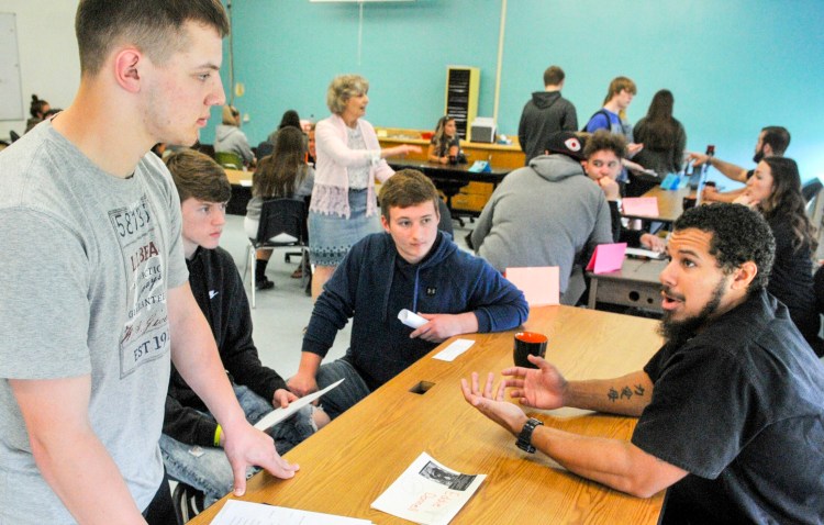 Class of 2012 graduate Eddie Donnell, far right, talks to students about his career as a nurse during an alumni event Thursday at Gardiner Area High School.