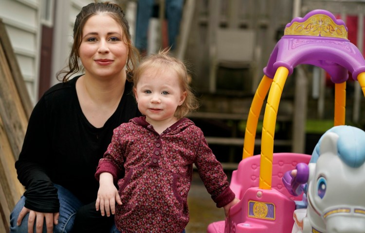 Tiara Marsh and her 18-month-old daughter, Adelyn Swain, pose for a photo at their home in Saco.