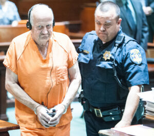 Albert Flick is led out of the courtroom following his initial appearance in the Androscoggin County Courthouse in Auburn last month (Russ Dillingham/Sun Journal)