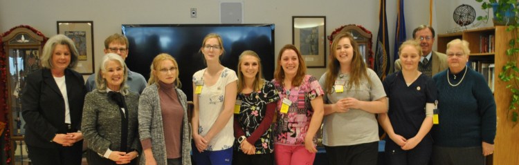 Workforce Development Training partners congratulate the latest class of Certified Nursing Assistant graduates at Maine Veterans’ Home in Augusta. Front from left are  Monica Millhime, WMCA, regional employer assistant point; Kathleen Lewia, professional development instructor; Rhona Suga, R.N., MVH Director of Nursing; and Crystal Leland, Sarah Lachance, Bethany Laflin, Grace Lathrop, Kimberly Banks, CNA graduates; and Ida Hall, R.N., classroom instructor.  Back from left are Myles Robert, WMCA employment and training specialist; and Zane Clement, AACE director. 