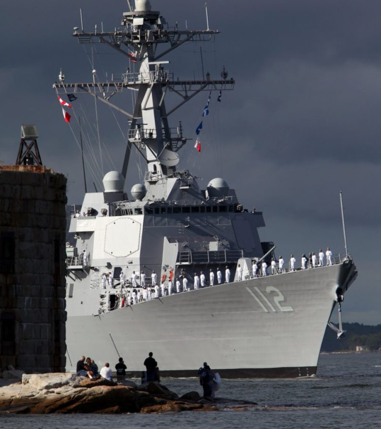 Sailors stand at the rail of the USS Michael Murphy, the last of the U.S. Navy's original run of 62 Arleigh Burke-class destroyers, as the BIW-built ship heads down the Kennebec River off Phippsburg in 2012. 