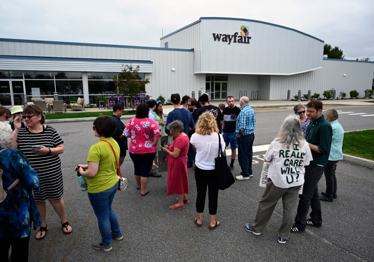 Employees, supporters and journalists gather outside Wayfair in Brunswick as workers walked out Wednesday to protest sales of furniture to a contractor that operates migrant detention centers on the southern border. 