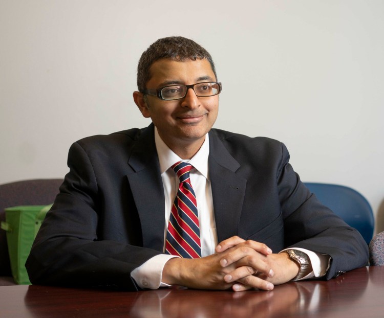 Dr. Nirav Shah, the new director of the Maine Center for Disease Control and Prevention, poses for a photo at the CDC offices in Augusta on June 10. He says that with his new position, "I am now in that sliver of people who got their dream job not once, but twice."