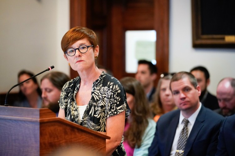 Patricia Rosi, CEO of Wellness Connection, listens to a question from a member of the Veterans and Legal Affairs Committee during a hearing Monday on rules for marijuana businesses. A lobbyist for Wellness Connection said the company will consider suing the state if it can't participate in the recreational market because of the proposed regulations.