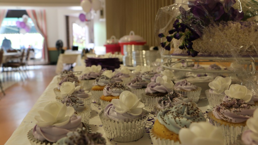 The bride made cupcakes for guests and friends and family brought dishes for the potluck dinner.