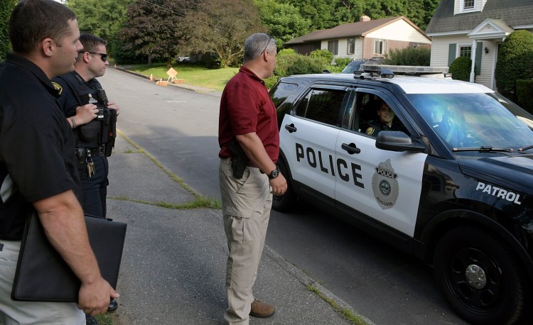 Augusta police canvass the area Tuesday after an armed robbery of the Mobil Mart convenience store on Bangor Street in Augusta. 