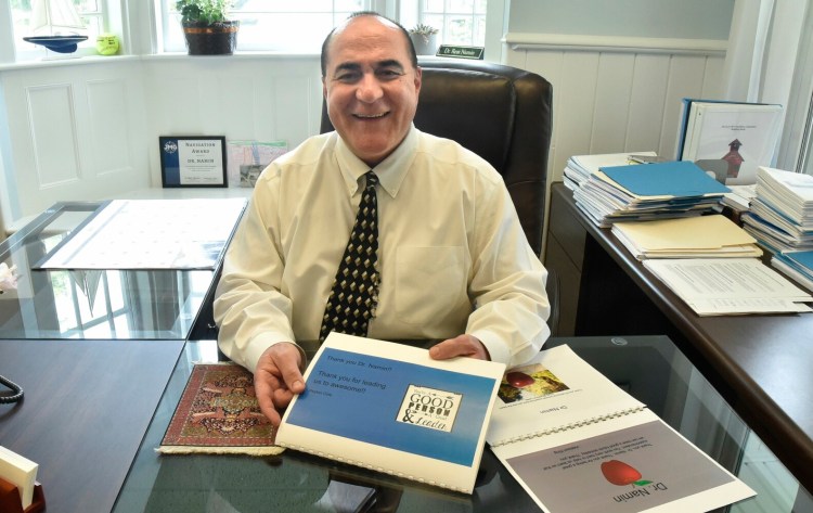 SAD 49 Superintendent Reza Namin holds a gift from the Benton Elementary School fifth grade class that states "Thanks for leading us to awesome" while reflecting on his position July 9. Namin is resigning from the job, effective Aug. 2.