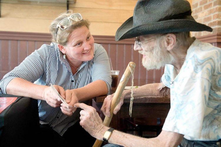 Claudia Williams, daughter of baseball legend Ted Williams, talks with Bob Greeley of Lisbon Falls on Saturday. 