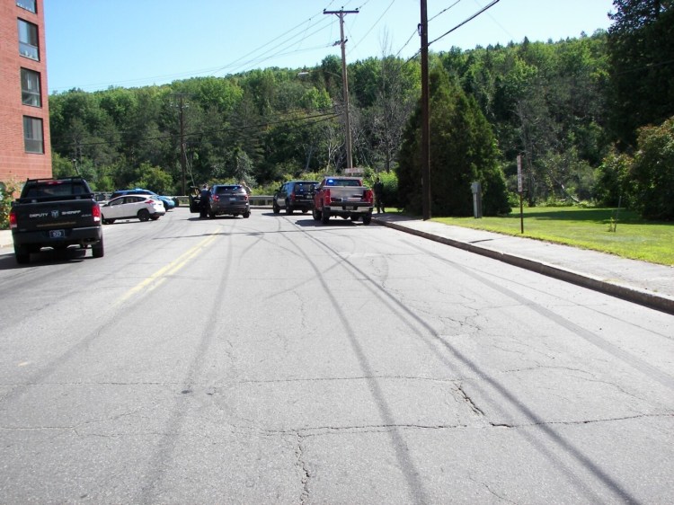 Police take Zachary Yahn, 27, of Dixfield into custody Sunday morning in Rumford.
