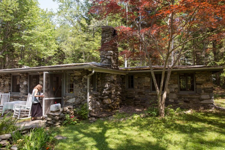 Nancy Gibson-Nash walks inside one of the Illustration Institute artist residency homes on Peaks Island. 