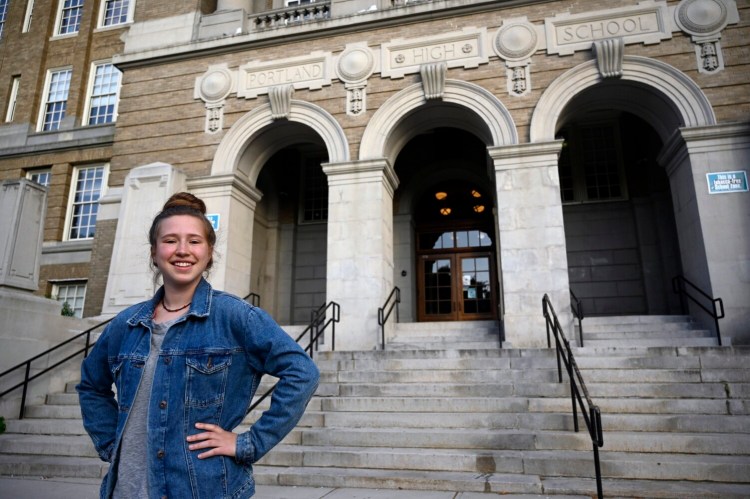 Meg Baltes, a Portland High School junior, stands in front of the school. "I think things are handled very swiftly and very aggressively at Portland," Baltes said of discipline problems there. More students are choosing to go to Portland High over Deering High this year, partly because of perceived discipline issues at Deering. 