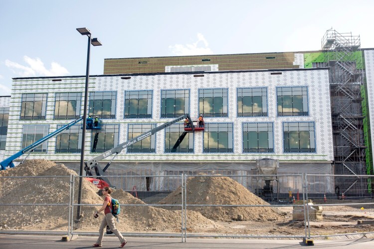 Construction continues on Idexx's headquarters expansion project in Westbrook as employees leave work in early August. The company could potentially tap a $16 million corporate tax break if it adds 80 new employees a year for 10 years.