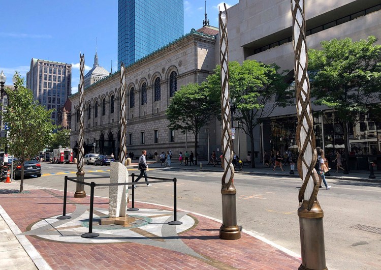 Light spires and one of the stone pillars stand along Boylston Street in Boston on Monday to memorialize the Boston Marathon bombing victims at the sites where they were killed. Martin Richard, Krystle Campbell and Lingzi Lu were killed when bombs were detonated at two locations near the finish line on April 15, 2013.