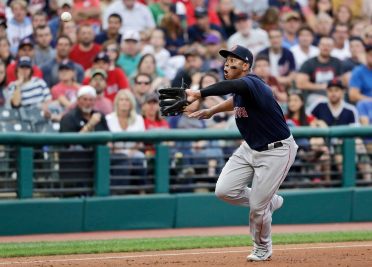 Boston's Rafael Devers fields a ball hit by Cleveland's Carlos Santana in the third inning of the Indians' 6-5 win Monday in Cleveland.