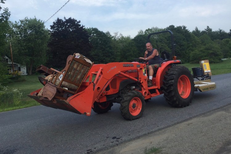 Coopers Mills Volunteer Fire Department member Mike King creatively works to move auction donations at the fire station.  CMVFD members and other community members contribute hundreds of volunteer hours toward the annual fundraiser. 