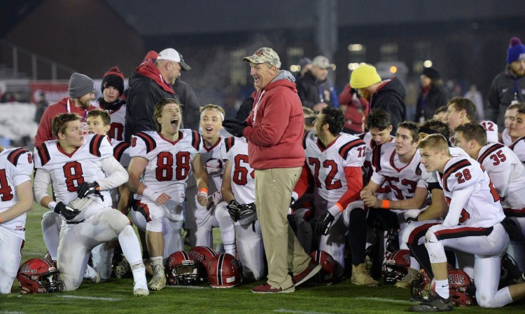 Wells head coach Tim Roche gives a postgame speech after his team won the 2018 Class D  state championship in Orono.