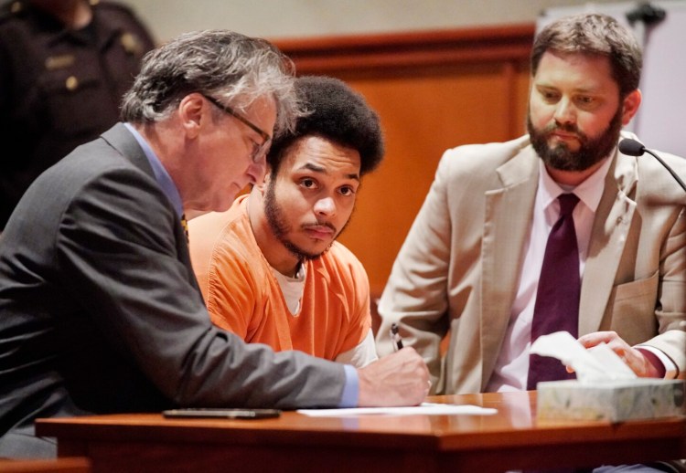 Tyrese Collins looks up while reviewing paperwork Tuesday with his attorneys William Maselli, left, and Erik Paulson before pleading guilty to manslaughter.