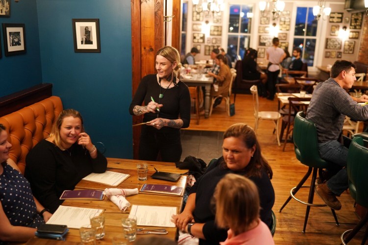 East Ender mixologist Rachel Best takes drink orders from guests in the upstairs lounge.