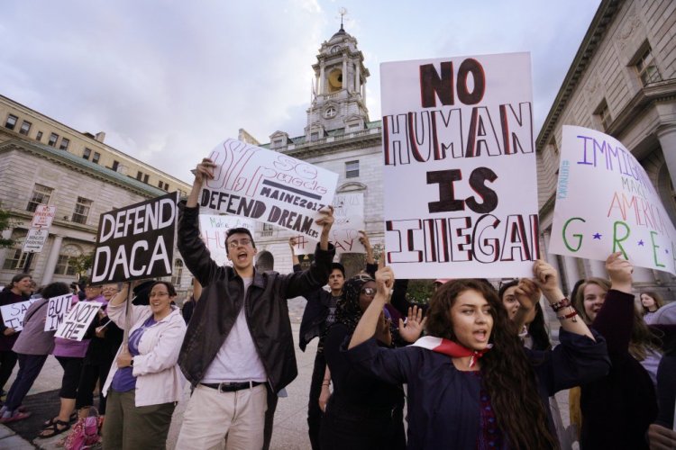 Kathleen Armenta, holding a sign saying "No human is illegal," chants "D-A-C-A, Dreamers have the right to stay" with other people rallying to support DACA, or Deferred Action for Childhood Arrivals, at Portland City Hall in September. Armenta is a freshman at Bowdoin College from Tucson, Arizona. She says her parents came to the United States from Mexico while she was in her mother's womb.