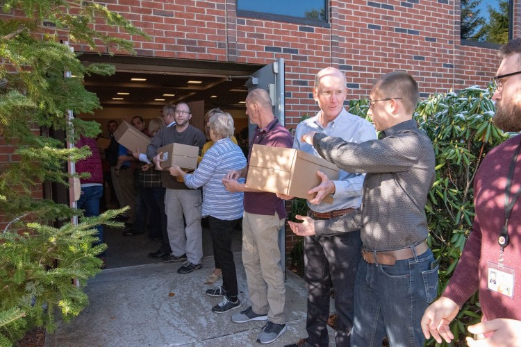 Hannaford workers load boxes of food into a van to be delivered to the food pantry at the East End Children's Workshop in Portland Wednesday. The activity capped an announcement that the Scarborough-based supermarket chain is pledging $1 million to create 90 school-based food pantries throughout the Northeast to help combat childhood hunger.