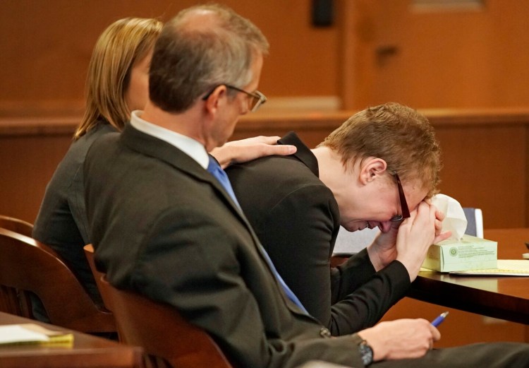 Sharon Carrillo puts her head in her hands and cries while Assistant Attorney General Donald Macomber delivers his opening statement Friday in Carrillo’s trial. Carrillo is charged with depraved indifference murder in the 2018 death of her 10-year-old daughter, Marissa Kennedy. With Carrillo are her attorneys, Laura Shaw and Christopher MacLean.