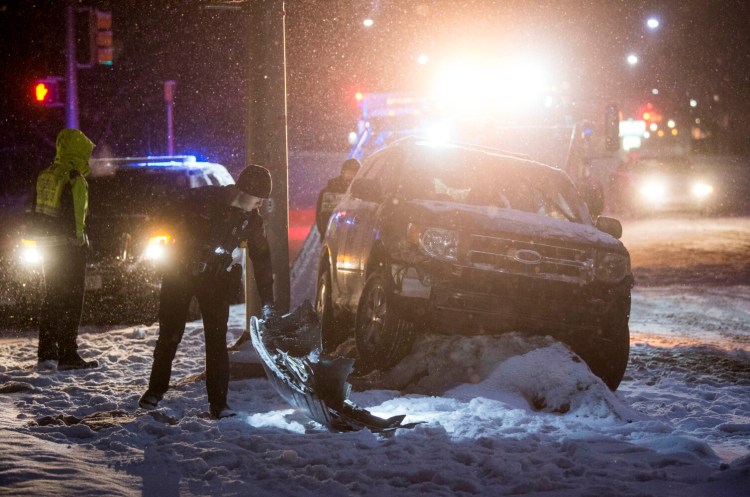 A late model SUV rests near a light pole at the intersection of Bridge Street and Water Street in Waterville on Tuesday. The vehicle struck another car on Main Street before hitting the pole on Bridge Street. According to police, alcohol is suspected as the cause. 