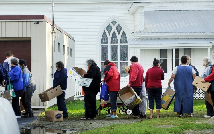 Staff photo by Andy Molloy
People line up for food Thursday outside the United Methodist Church in Richmond.  Several dozen people stood in line for food from the mobile Good Shepherd Food Bank.