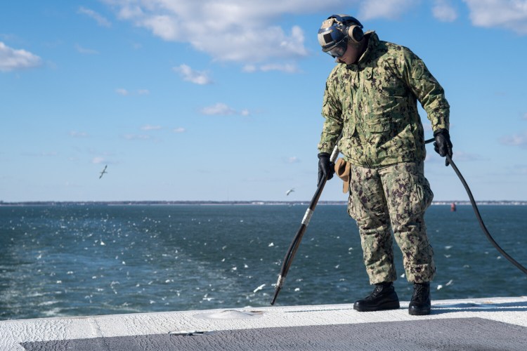 U.S. Navy Aviation BoatswainÕs Mate (Handling) Airman Apprentice Kevin White, from Waldoboro, blows out padeyes on the flight deck of the aircraft carrier USS John C. Stennis (CVN 74) in Norfolk, Virginia, Dec. 5. The John C. Stennis is conducting routine operations in support of Commander, Naval Air Force Atlantic. 