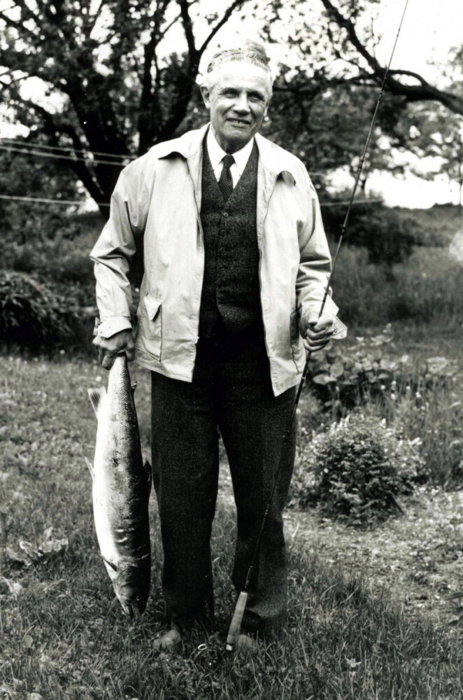 Leon Leonwood Bean holds a 19-pound salmon in New Brunswick, Canada, in 1945. 