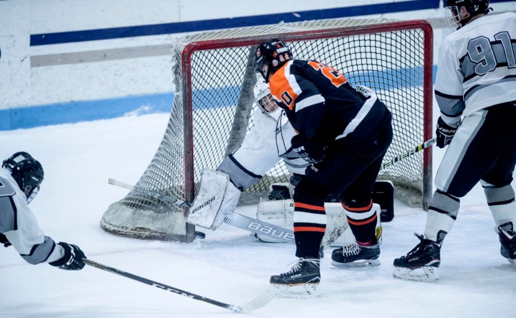 Gardiner High School's Jared Shaw (20) scores on the rebound on Kennebec RiverHawks goalie Bryce Gunzinger for the 6-5 win in overtime at Colby College in Waterville on Wednesday.