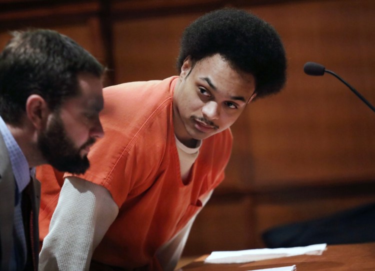 Tyrese Collins speaks to defense attorney Erik Paulson in court in Portland on Monday during Collins' sentencing hearing in the shooting death of Jack Wilson. 