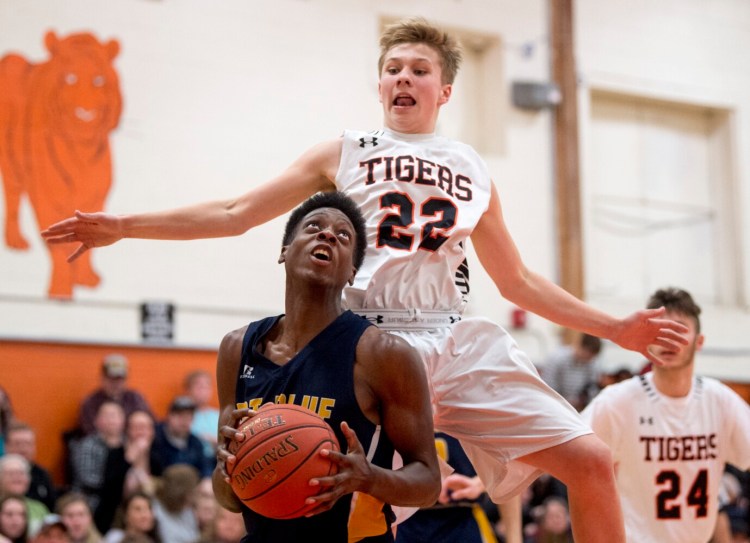 Gardiner junior Kyle Adams (22) defends Mt. Blue senior Bradley Shamba during a Kennebec Valley Athletic Conference Class A game Friday night in Gardiner.