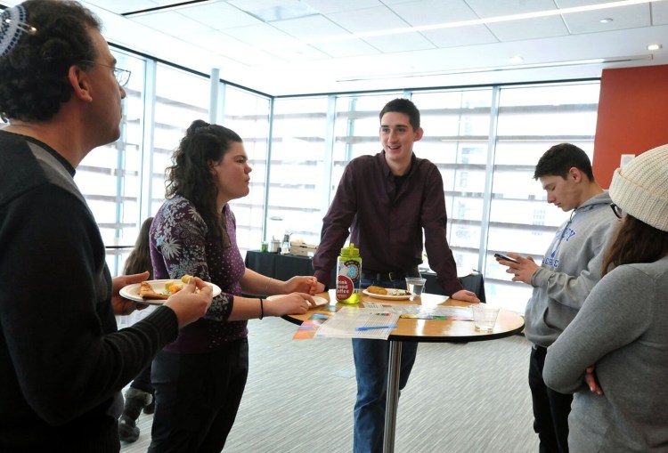 Colby College freshman Andy Blake, center, leads the conversation Thursday during a lunch that celebrated the Faith, Class and Community course at Colby. Blake volunteered at a homeless shelter while taking the course. Pictured with Blake from left is David Freidenreich, a professor in religious studies that taught the course, Colby students Hannah Smith-Erb, Lane Kadish, Sarah Kaplan.