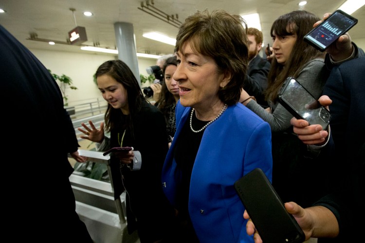 Sen. Susan Collins R-Maine, talks to reporters before attending the impeachment trial of President Trump on Tuesday. 