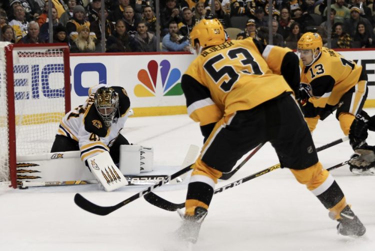 Bruins goaltender Jaroslav Halak keeps the puck out of the net as Pittsburgh's Teddy Blueger (53) and Brandon Tanev look for a rebound during Boston's 4-3 loss on Sunday in Pittsburgh.