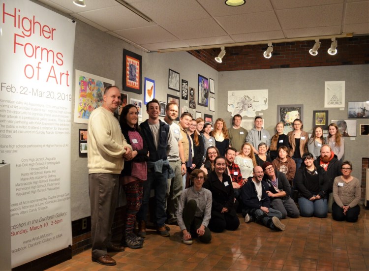 Local students teachers and parents gather after they finished installing the exhibit for the Higher Forms of Art 2019 exhibition. 