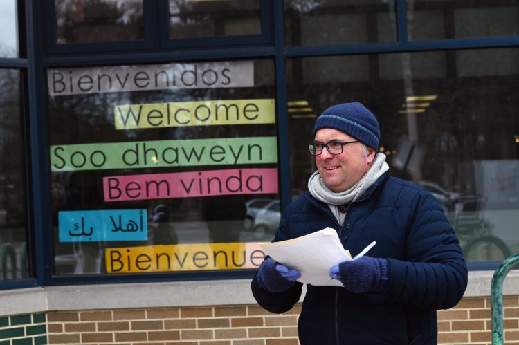 Ted Hummel, a teacher at Reiche School in Portland, was working at King Middle School on Monday to connect students with laptops.