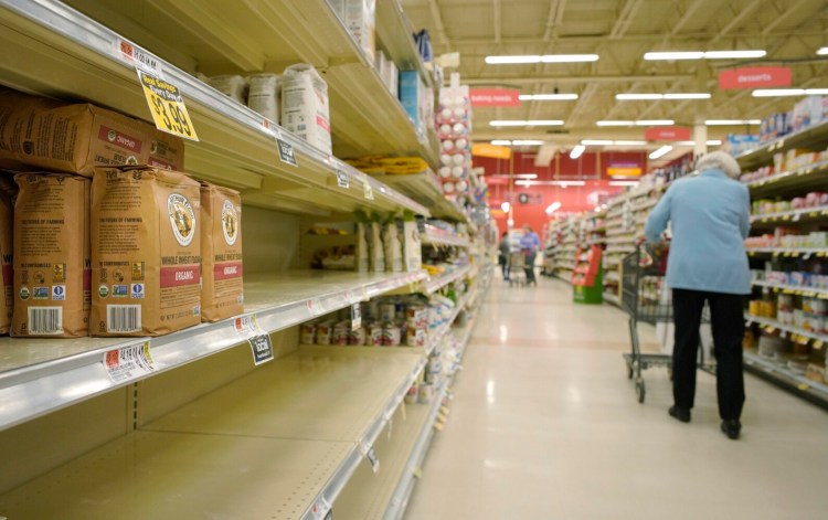 Shelves in the flour section of Hannaford supermarket in Scarborough were mostly bare in late March. While supermarkets and grocery stores still have plenty of food, certain basic items are likely to remain in short supply for months.