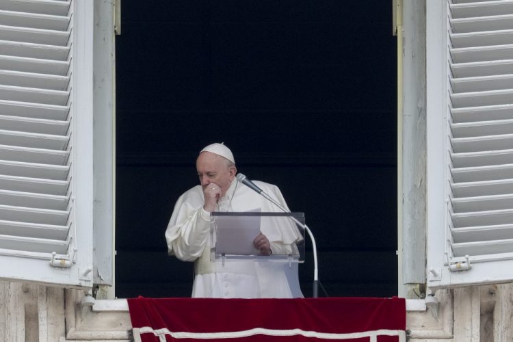 Pope Francis coughs during the Angelus noon prayer he recited from the window of his studio overlooking St. Peter's Square, at the Vatican, Sunday.