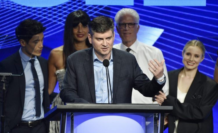 In this Aug. 4, 2018 file photo, Michael Schur, center, creator and executive producer of the television series "The Good Place," accepts the Outstanding Achievement in Comedy Award as cast members, from left, Manny Jacinto, Jameela Jamil, Ted Danson and Kristen Bell look on at the 34th annual TCA Awards during the 2018 Television Critics Association Summer Press Tour, in Beverly Hills.