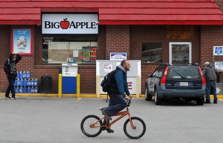 Customers and others Tuesday at the Big Apple Store at 33 Elm St. in Waterville. The store was robbed at knife point early Monday morning. 