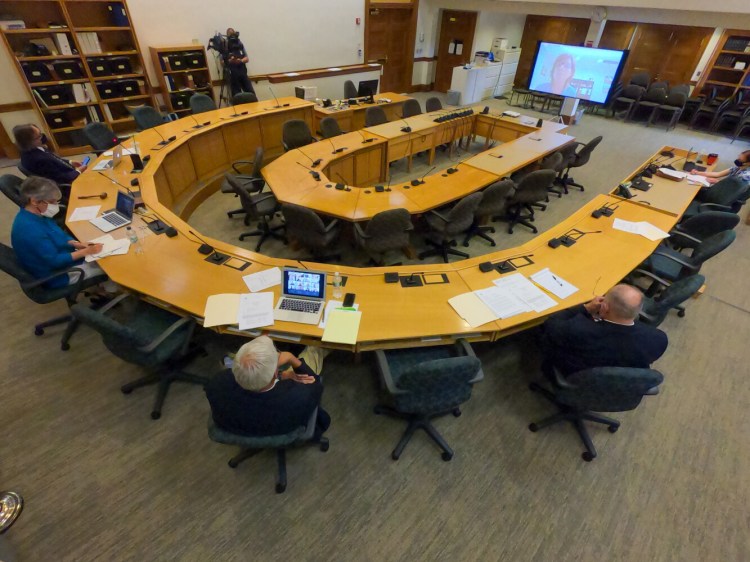 Appropriations Committee co-chairs and party leaders watch as Administrative and Financial Services Commissioner Kirsten Figueroa testifies on screen Friday at the State House.