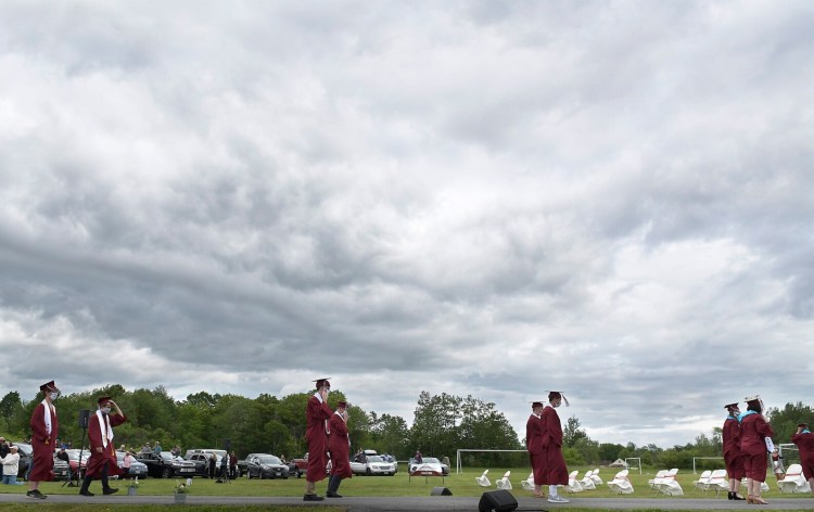 Seniors march a safe distance from each other Sunday during the Richmond High School graduation.